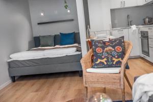 a living room with a couch and a chair at NG Apartments in Bergen +9 photos