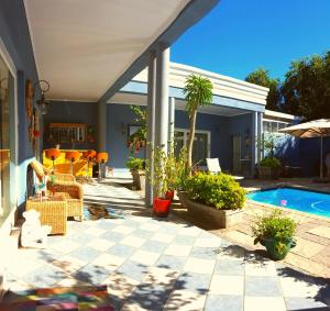 a house with a patio with a swimming pool at 1AA Wilhelmina Luxury Suites in Franschhoek