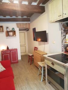 a living room with a red couch and a tv at La Casina in Chiusi