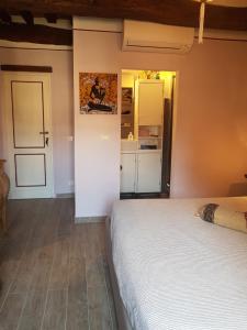 a bedroom with a bed and a door to a kitchen at La Casina in Chiusi