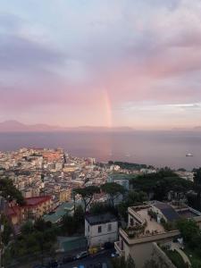 a view of a city with a rainbow in the sky at Bed in Naples in Naples