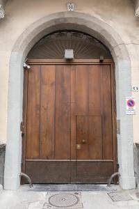 
a door leading to a small room with a wooden door at Il Salotto della Regina in Naples
