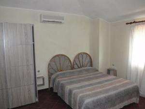 オルメードにあるAjò sardiniaのベッドルーム1室(ベッド1台付)
