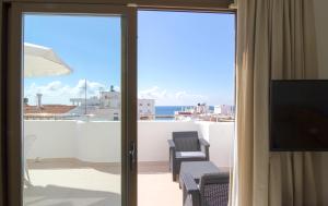 a sliding glass door with a view of the ocean at Apartamentos Bon Lloc in Santa Eularia des Riu