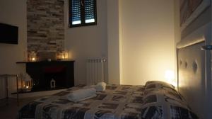 a bedroom with a bed with a fireplace and a window at Marselo B&B in Bari
