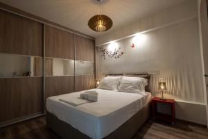 - une chambre avec un grand lit et des draps blancs dans l'établissement Acropolis Koukaki Newly Renovated 55sq.m Apartment, à Athènes