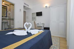 Postel nebo postele na pokoji v ubytování Hotel7Bello