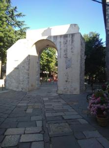 an archway in a park with trees and flowers at Đana in Cres