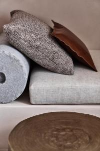 a group of pillows sitting on top of a table at Istoria, a Member of Design Hotels in Perivolos