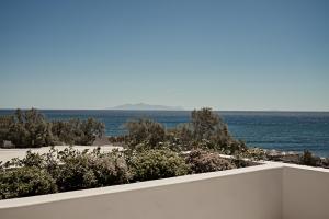 a view of the ocean from the balcony of a house at Istoria, a Member of Design Hotels in Perivolos
