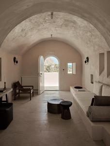 a living room with a couch and a table at Istoria, a Member of Design Hotels in Perivolos