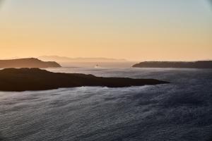 a view of the ocean at sunset at Istoria, a Member of Design Hotels in Perivolos