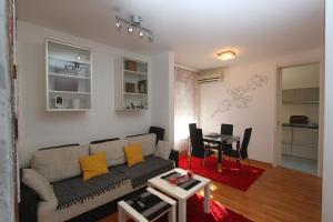 a living room with a couch and a table at Twin Belville Apartments in Belgrade