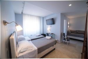 Posteľ alebo postele v izbe v ubytovaní B&B Attico 33