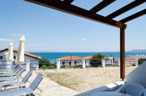 a view of the beach from the patio of a villa at ''The Boulas'' Rooms in Megalochori