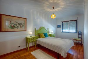 Giường trong phòng chung tại Like-home Boa Onda House