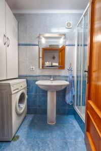 a bathroom with a sink and a washing machine at Like-home Boa Onda House-T4-Ericeira center in Ericeira +13 photos