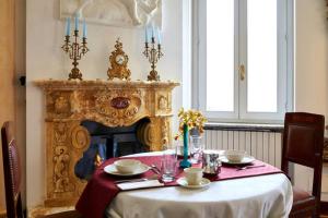 a dining room with a table and a fireplace at Villa Puccini Bed & Breakfast in Lecco