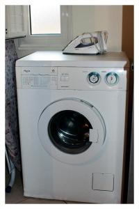 a washing machine with a phone on top of it at Casa Vacanza "La Chiazza di Grutti" in Grotte