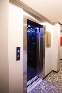 a elevator with a glass door in a building at Long Stay İstanbul Residence in Istanbul