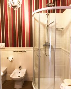 a bathroom with a shower and a toilet and a sink at B&B Civico22 in Torre Maggiore