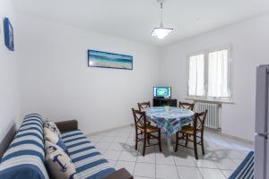 a living room with a table and a couch at Residence Kimba in Rimini