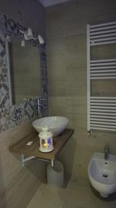 a bathroom with a white sink and a toilet at Marselo B&B in Bari +7 photos
