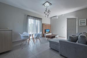 a living room with a couch and a table at Peristera in Katelios