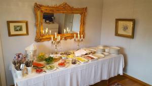 a table with food on it in front of a mirror at Ollila Rantamökit in Kerimäki