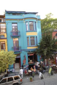 a blue building with people sitting outside of it at Kybele Hotel in Istanbul