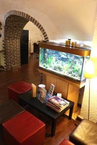 a living room with a fish tank and a table at Auberge Saint Martin in La Brigue