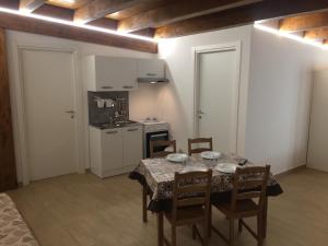 a dining room with a table and chairs and a kitchen at I Villini in Pescara