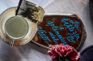 a cup of coffee and a plate with a brush and flowers at Holiday home Porta alla Fonte in Massa e Cozzile