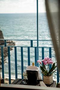 a table topped with a glass of water next to a beach at Oasi Relais in Vico Equense