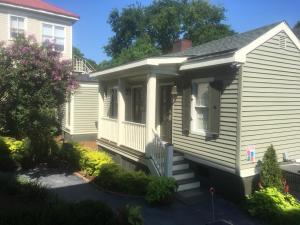 a small white house with a porch at 22 Charlotte in Charleston