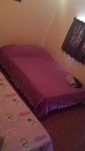 Postel nebo postele na pokoji v ubytování Hospedaje Rampolla's