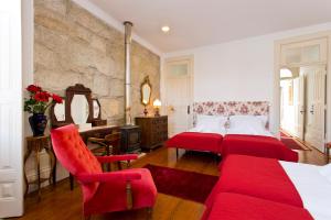 a hotel room with two beds and a fireplace at Casa Portugueza Experience in Porto