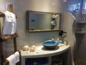 a bathroom with a blue sink and a mirror at Santoxenia luxury villa in Kamari