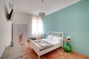 a bedroom with a white bed and a window at BUTTERFLY B&B in Lecce