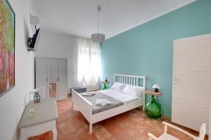 a bedroom with a white bed and a green lamp at BUTTERFLY B&B in Lecce
