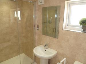 a bathroom with a sink and a glass shower at Cornerstone in Portland