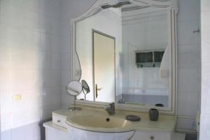 a bathroom with a sink and a large mirror at Apartmani Tara Medulin in Medulin +78 photos