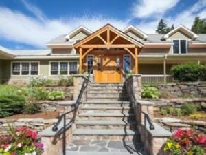 una casa con portico con scale che conducono alla porta d'ingresso di The Inn at Quail Run a Wilmington