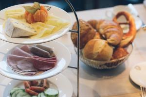 a bunch of different types of bread and pastries on plates at Das Wildeck Hotel & Restaurant in Abstatt
