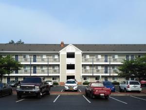 un gran edificio de apartamentos con coches aparcados en un aparcamiento en Motel 6-Greensboro, NC - I-40, en Greensboro