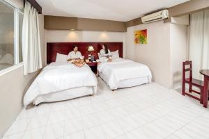 Postel nebo postele na pokoji v ubytování Hotel Maria del Carmen