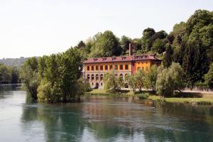 a building sitting on the side of a river at "LA TAVERNA" B&B in Airuno