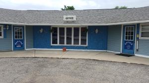 a blue building with a sign that reads office at Burr Oak Motel in Algona