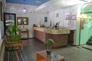 a lobby of a restaurant with a counter and chairs at Hotel - Pousada do Arco Iris in Osasco