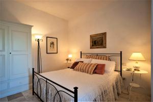 a bedroom with a bed and two lamps and a door at Agritourist Podere in Asciano